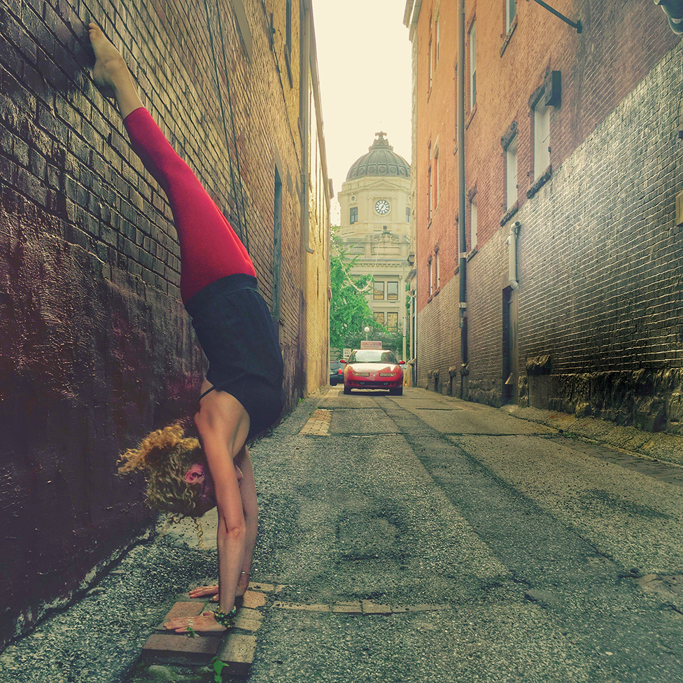Asanas, or postures, such as this handstand, "allow us to practice integrating all of the limbs. Working toward a goal — being present in the posture, content with all that arises mentally and physically — is yoga." | Courtesy photo