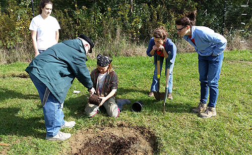 Amy Roche (second from right), the orchard’s outreach chair and chair of the board of directors, strives to dream, build, and share an orchard community. | Photo courtesy of Bloomington Community Orchard