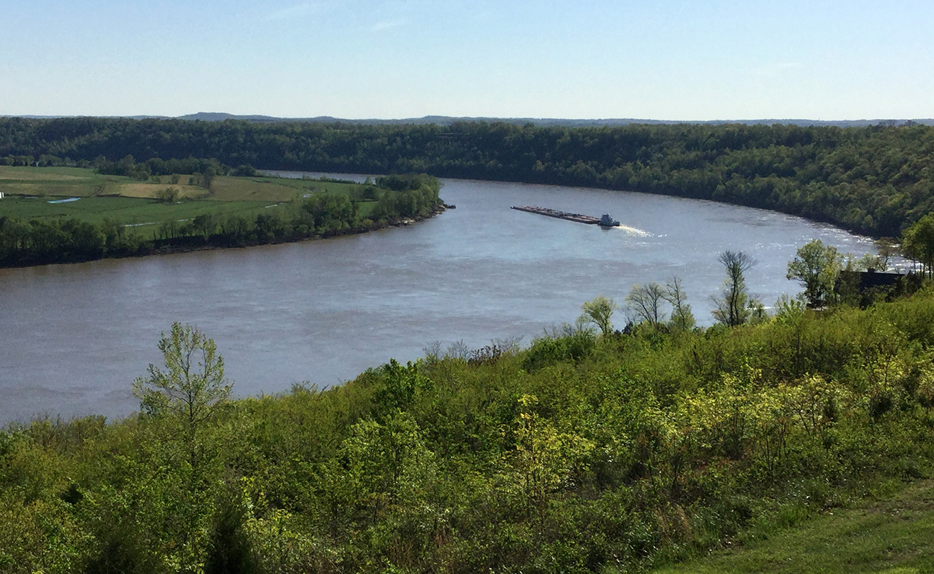 From a vista along the ADT in Leavenworth, Indiana, a tugboat pushes a barge around a bend in the Ohio River. | Photo by Ron Eid
