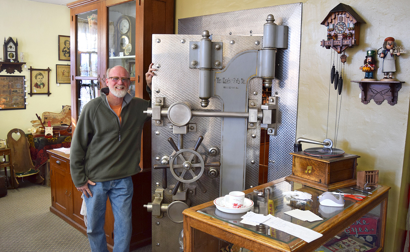 Carriage House Antiques is a combination of a museum, ice-creamery, and a trinket garrison. The proprietor, Jim Meyer (pictured here), provides tours of the building, which was once a bank. | Photo by Michael Waterford