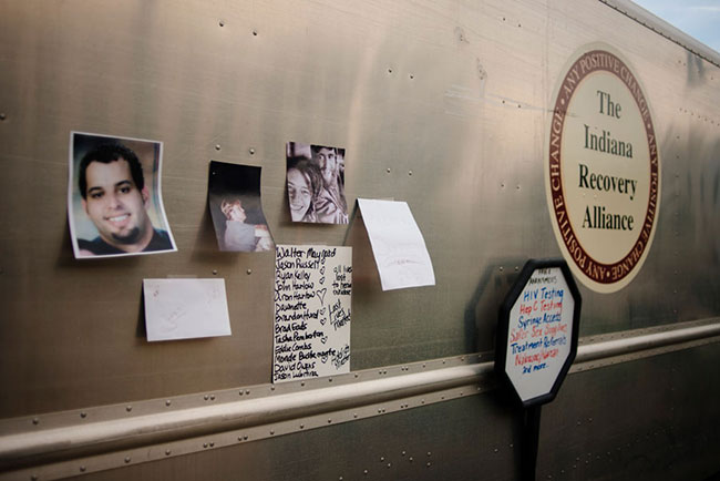 Photos and names of those lost to overdoses are taped to the IRA van during a vigil on August 31. | Photo by Natasha Komoda