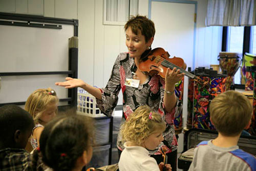 Brenda Brenner teaches violin to Fairview Elementary School students in the Fairview Violin Project. | Courtesy photo