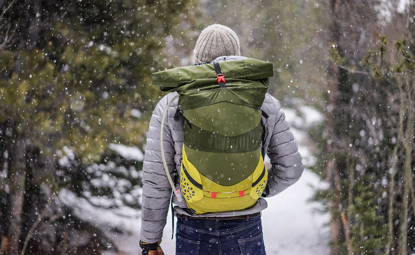 It is important to keep moving in order to stay warm while winter camping. | Photo courtesy of <a href="https://www.pexels.com/photo/man-facing-back-wearing-grey-and-black-stripe-jacket-during-winter-season-34043/" target="_blank">Pexels</a>