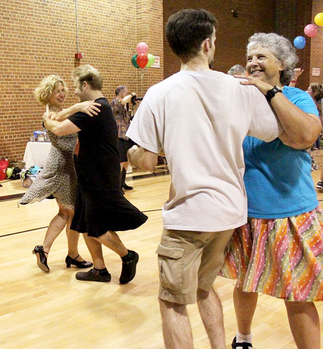 Cathy Meyer, right, the board chair of Bloomington Old-Time Music &amp; Dance, says the physical contact with others that comes with contra dance is what makes it "a lot of fun." | Photo courtesy of Cathy Meyer