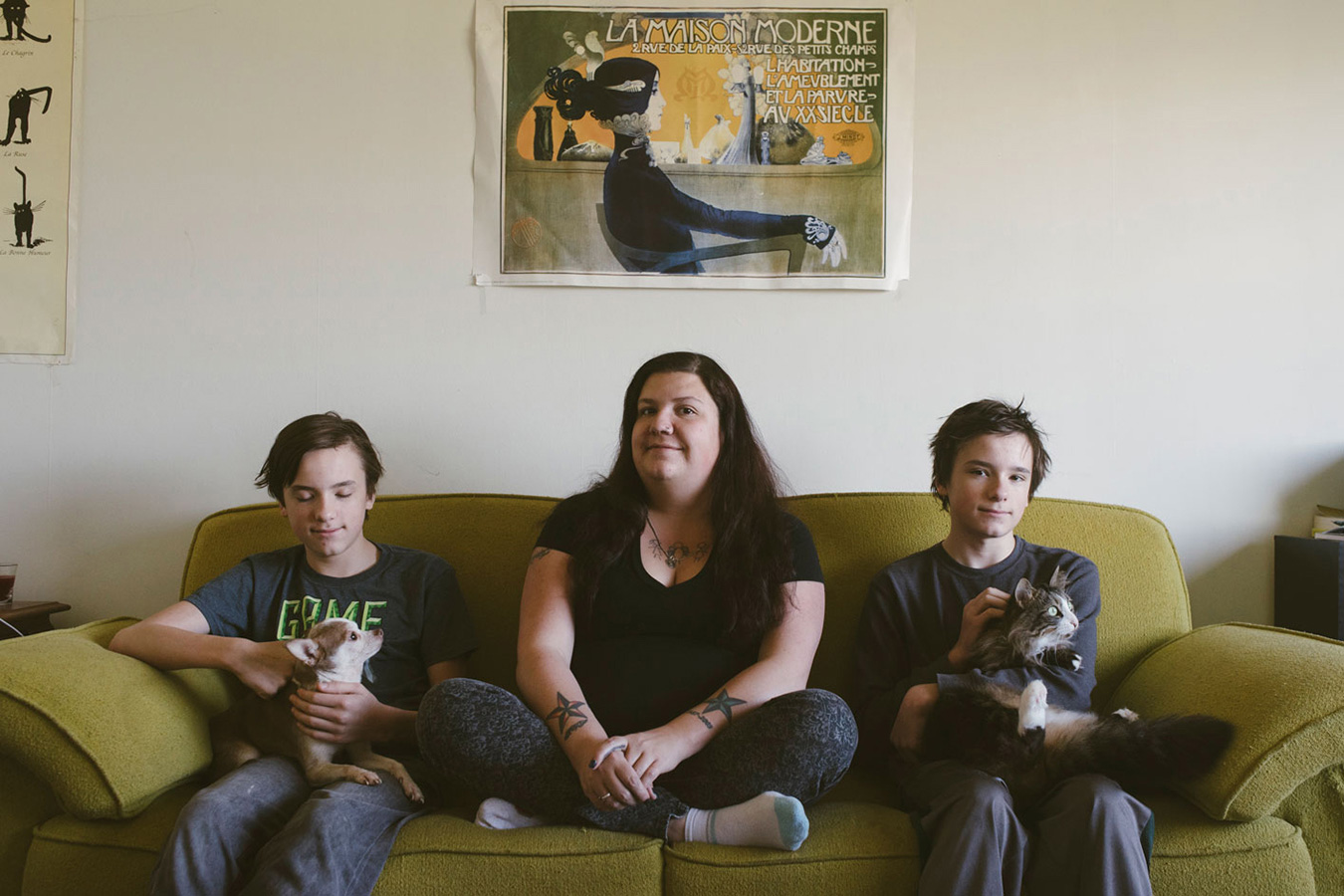 Laura Martinez sits with their twin sons, Korbyn (left) and Jarek, and their dog, Sancho, and cat, Gizzy. Martinez has dealt with food insecurity on and off throughout their life and has worked very hard to protect their sons from the stress of being food insecure. | Photo by Natasha Komoda