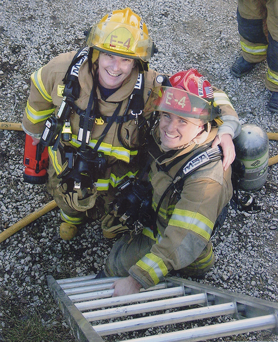 Jean Magrane (left), who became Bloomington's first woman firefighter in 1987, with Greg Lucas at the “Jiffy Treat training day” in 2006. The fire department is often allowed to use condemned buildings for training purposes before the buildings are destroyed, such as the old Jiffy Treat on East Kirkwood Avenue. | Courtesy photo