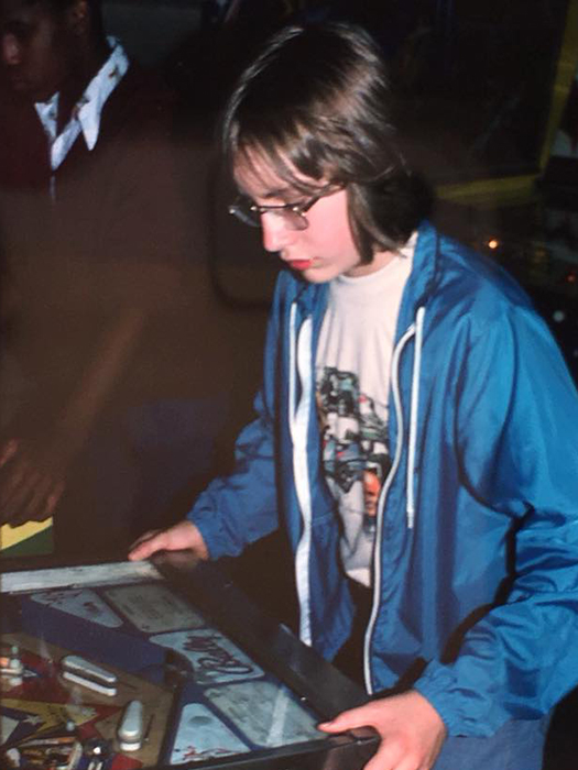 Johnson, playing pinball in the late 1970s, at about the age he caught a bus to Ontario, by himself, “to live off the land.” | Courtesy photo