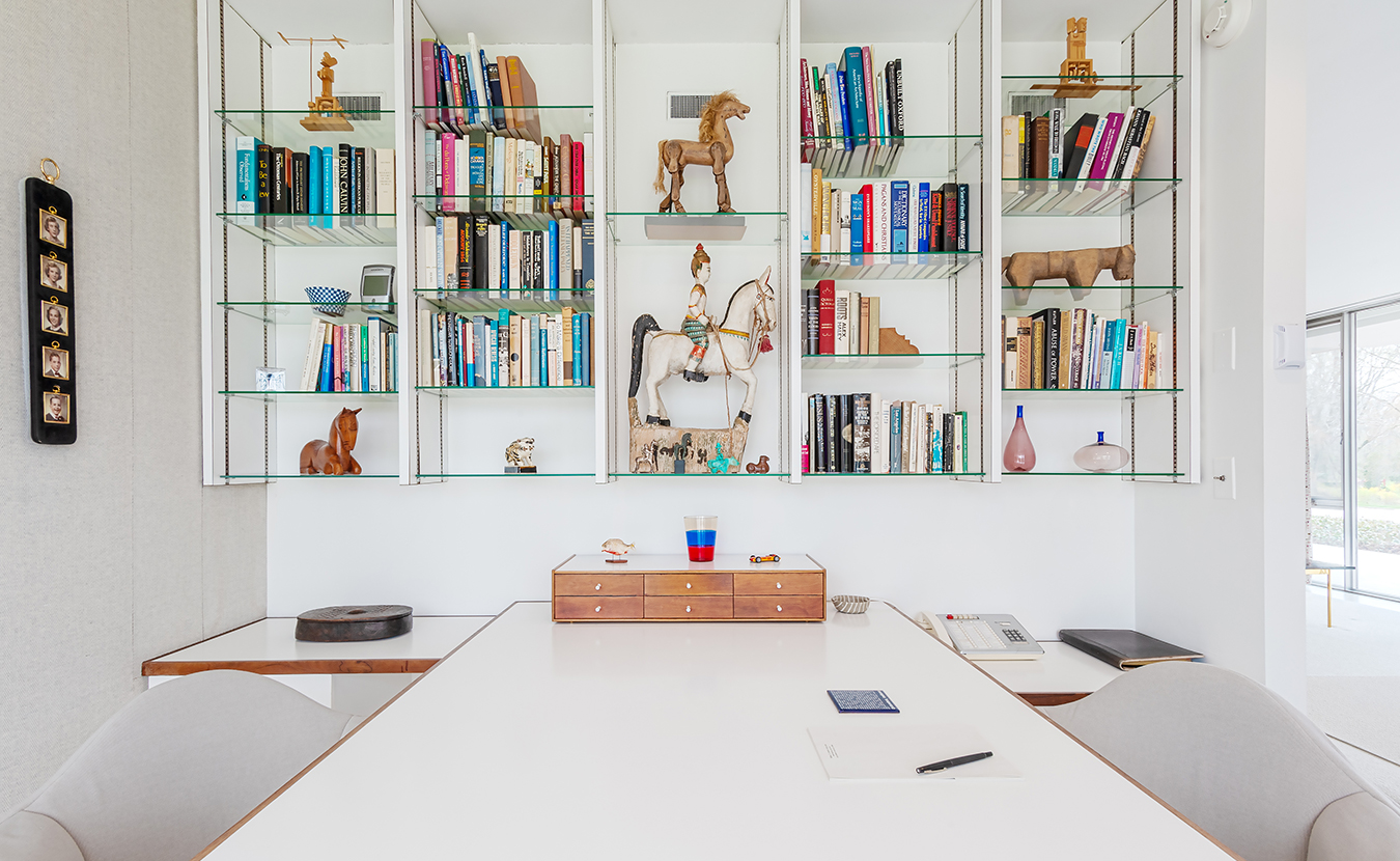 Miller's master bedroom office features a display of objects from around the world. The Millers' children can been seen in the photographs on the far left. | Photo by Adam Reynolds