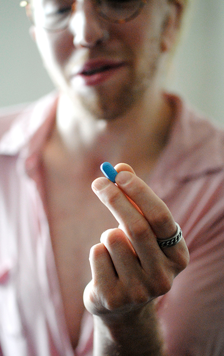 When Syd Bohuk’s alarm chimes, they swallow a bright blue pill, and continue with their day. Bohuk says this pill — PrEP, an HIV-preventive medication — has become a part of their daily routine, and is much less scary than they had originally anticipated. | Photo by Nicole McPheeters