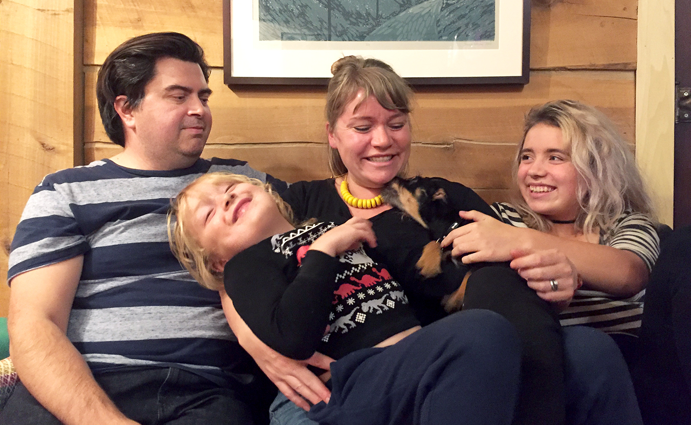 Lana, center, moved away from May Creek to go to school, but has since returned with her husband, John, and kids, Lucy (right) and Julian, to live in her childhood home. | Photo by John Mikulenka