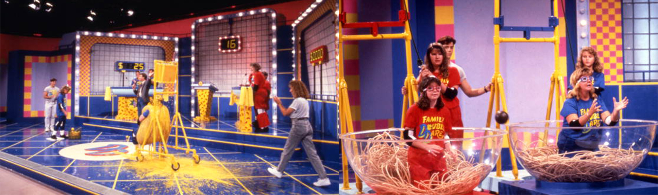 Families participate in challenges during Nickelodeon's 'Double Dare,' considered one of TV's messiest shows. Here, in 1990, someone dressed as a hotdog bun gets covered in "mustard" (left) and folks sitting in "spaghetti" try to catch falling "meatballs." | Public Domain