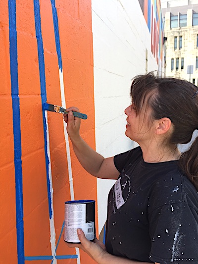 Eva Allen painted the mural 'Love This City' at the Mother Bear's Pizza east-side location last spring. She also painted 'You Belong Here' in Peoples Park in 2017 (see update below regarding 'You Belong Here'). | Limestone Post