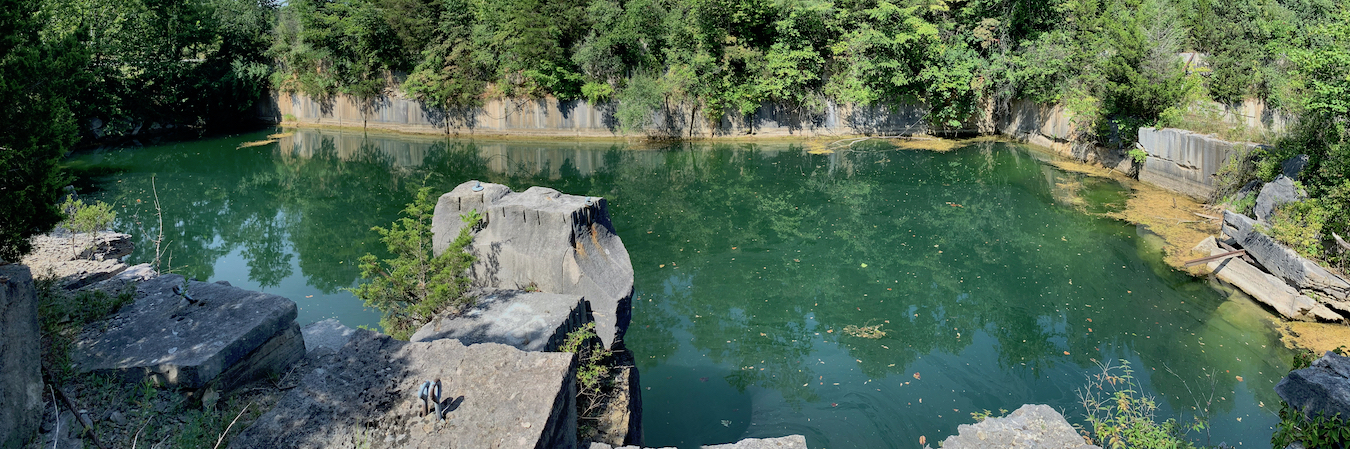 Longtime local residents have given some of the more popular quarries different names over the years. Before it was filled in, Rooftop was officially Adams Quarry but was also known as Sanders Quarry. The property being considered for a limestone heritage park includes two quarries that were favorite (if illegal) swimming holes for decades — Long Hole and Ice Box. This photo shows part of Long Hole, which was split in two when SR 46 was constructed. | Photo by Geoff McKim