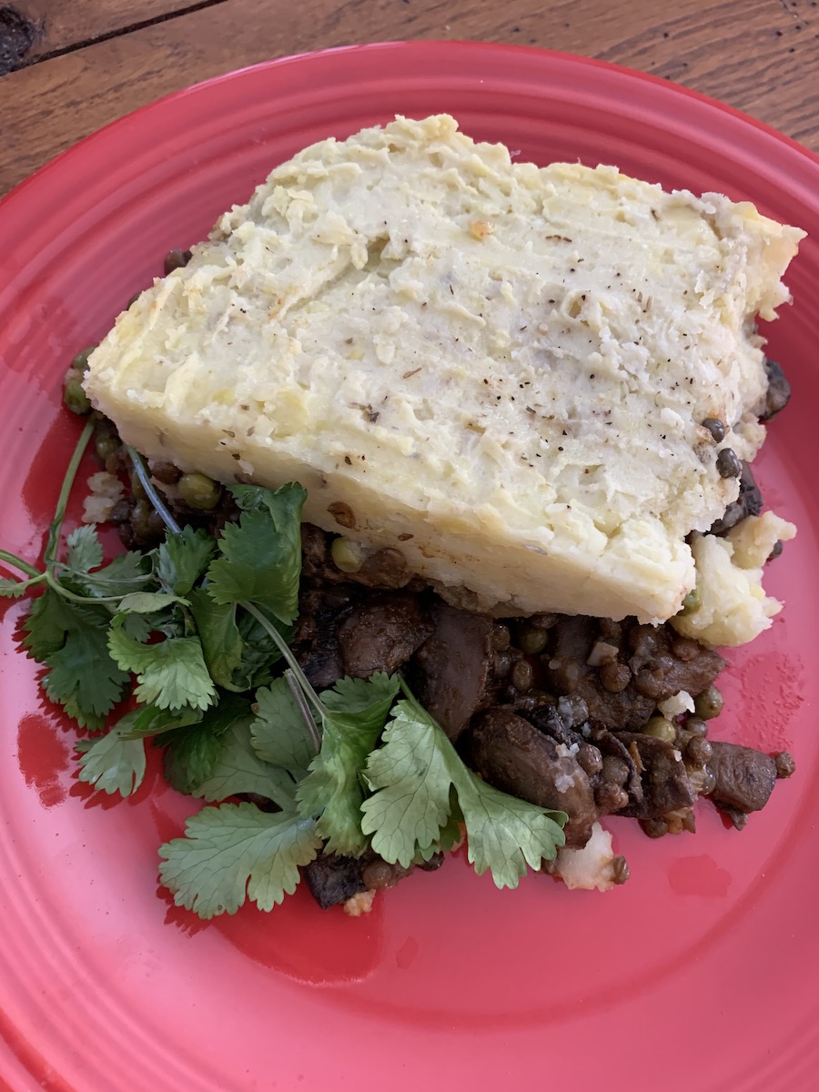 This hearty, savory pie combines lentils, red pepper, carrots, peas, onions, and mushrooms, with a “crowning glory” of mashed potatoes. | Photo by Ruthie Cohen