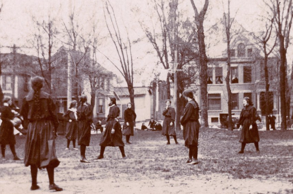 This photo, taken on April 22, 1899, shows a high school girls' game between Shortridge High School and the Y.W.C.A. in Indianapolis. A hoop and net (without a backboard) can be seen slightly above and to the right of center. The ball handler is to the left. High school nicknames and mascots would not become widely used until the 1920s. The photo is titled ‘Shortridge High School and Y. W. C. A. girls playing basketball, Indianapolis, Indiana, 1899’ and provided courtesy of <a href="http:indianaalbum.com" target=“_blank">IndianaAlbum.com</a> from the Nicolas Horn Collection.