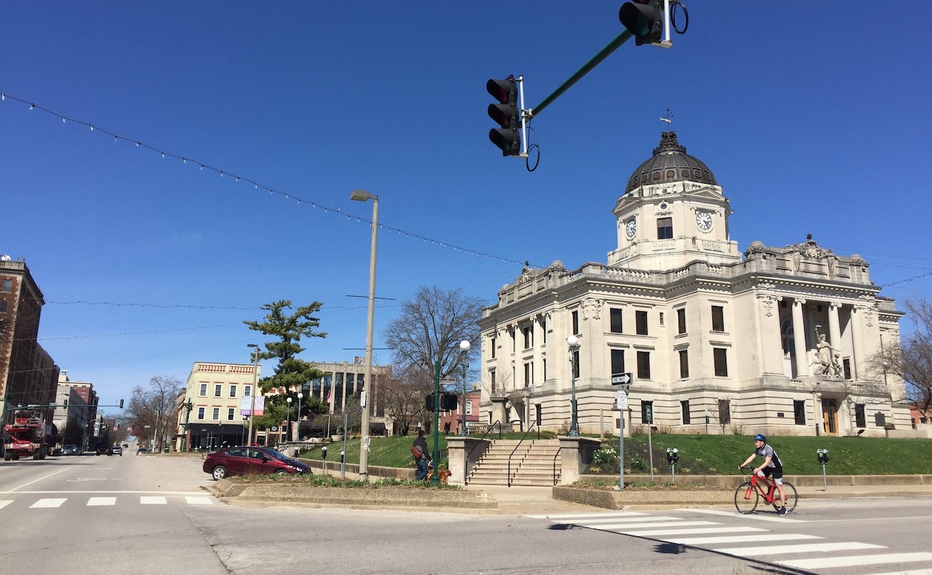 A lone bike rider on the nearly empty streets of Bloomington, Indiana, March 25, 2020. Local officials, organizations, and individuals have developed programs and resources to help people trying to cope during the COVID-19 crisis. | Limestone Post