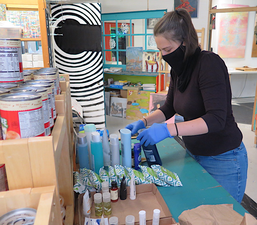 Volunteer Amie Messer organizes goods at the People's Open Pantry prior to opening on a recent Saturday morning. | Limestone Post